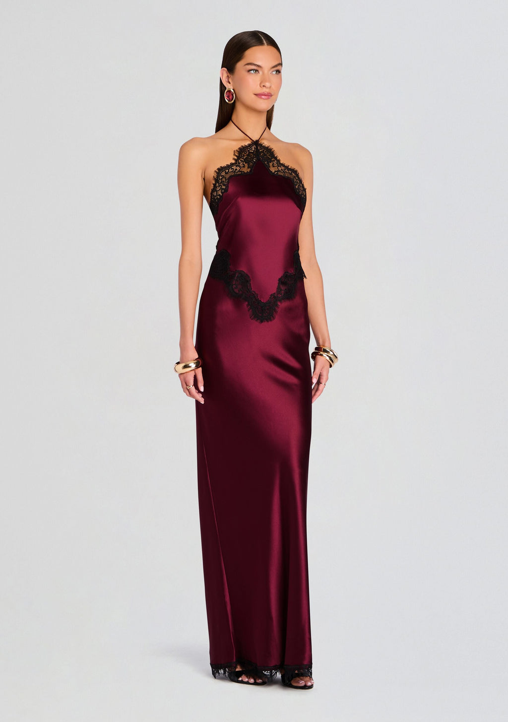 Full-length view of model in burgundy satin Everly Dress with black lace trim at neckline and hem