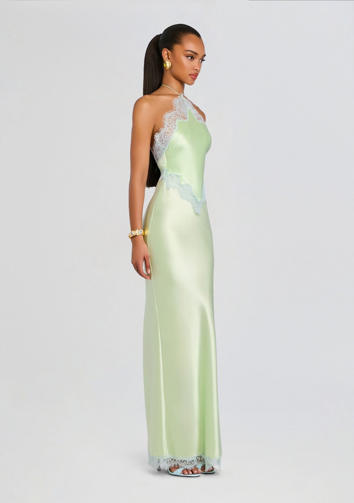 Full-length model in Everly Dress mint satin with lace trim along the neckline and waist.